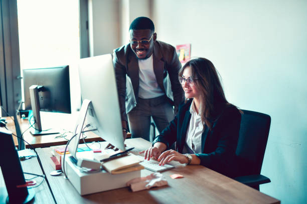 istock African Male Checking Progress Of Female Programmer In Office 1439816265