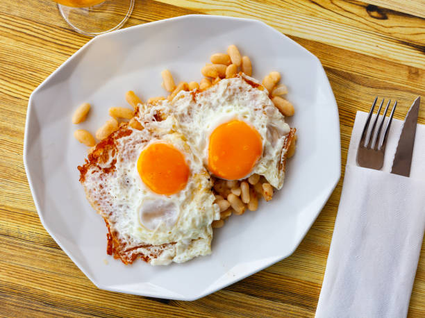 Fried eggs with stewed white beans for breakfast