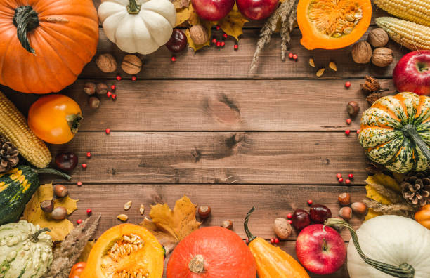 istock Fall flat lay composition frame, with various autumn pumpkins, vegetables, fruits and copy space on wooden background. 1439816425