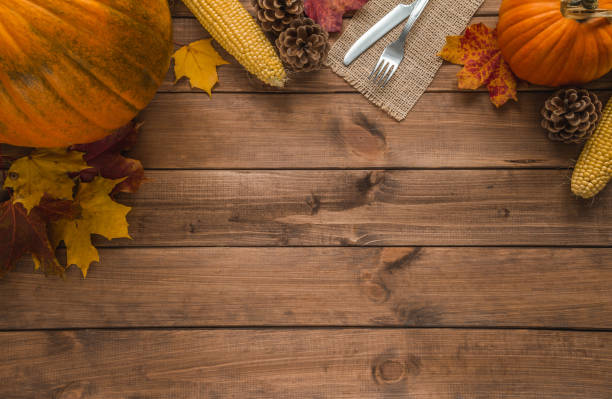 istock Fall flat lay composition for Thanksgiving. Autumn pumpkins and cutlery on jute material. Copy space on wood. 1439816465