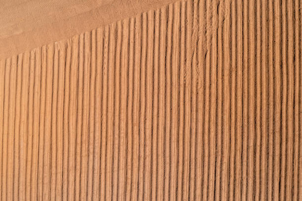 Freshnly ploughed soil in a field during springtime, preparation for seeding. Photographed from directly above.