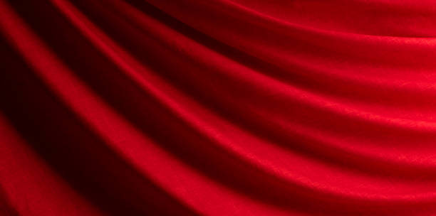 istock draped red silk fabric of satin weave, texture, background 1439818920