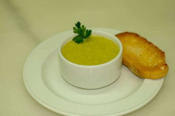 istock Zucchini cream with toast, served in a white bowl. 1439820189