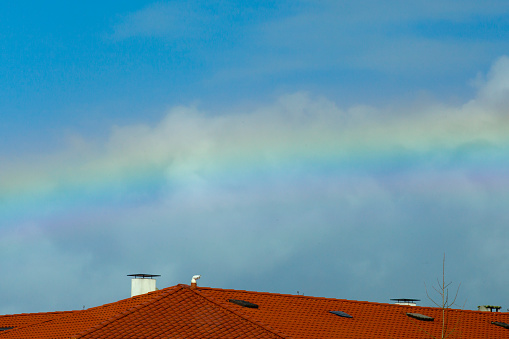 Rainbow over rooftops, townscape.  A Coruña province, Galicia, Spain. Camino de Santiago.