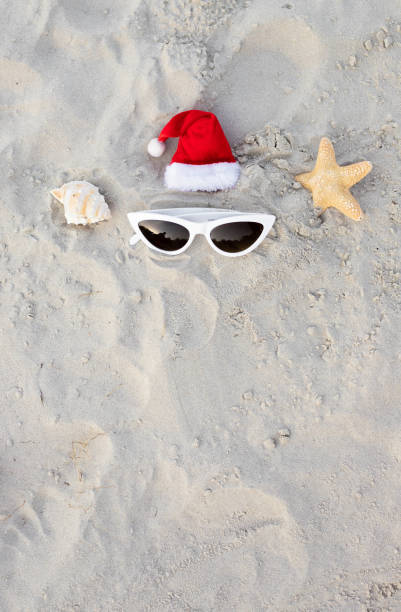 istock Santa Claus hat on the beach with sunglases and starfish 1439821173