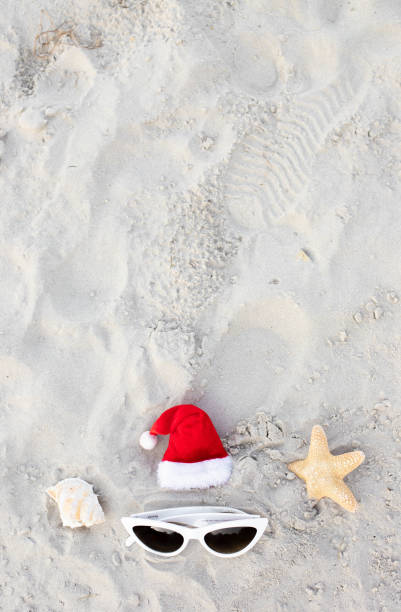 istock Santa Claus hat on the beach with sunglases and starfish 1439821174
