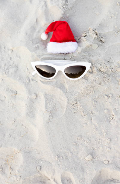 istock Santa Claus hat on the beach with sunglases 1439821179