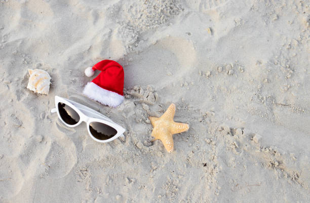 istock Santa Claus hat on the beach with sunglases and starfish 1439821180