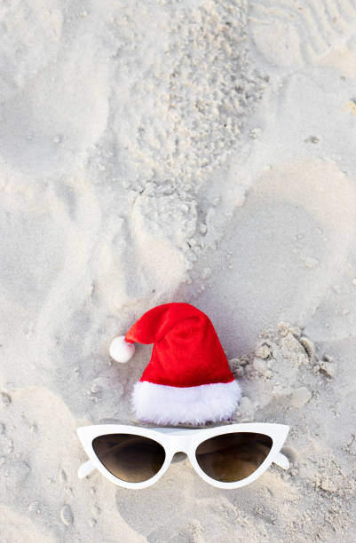 istock Santa Claus hat on the beach with sunglases 1439821395