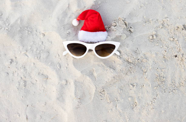 istock Santa Claus hat on the beach with sunglases 1439821398