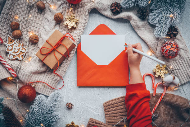 istock New Year's envelope with a letter in hands with a place for your text 1439823552