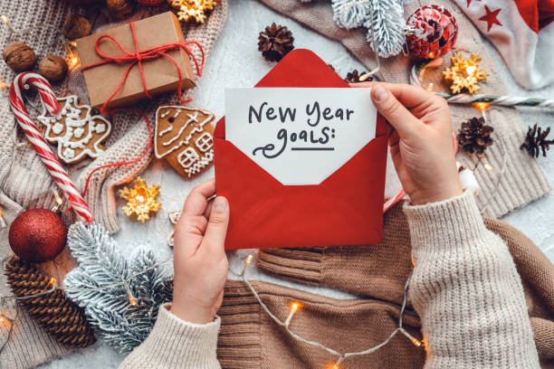 2023 goals paper sheet around christmas new year decorations. Planning year concept. Copy space. Flat lay. Top view stock photo