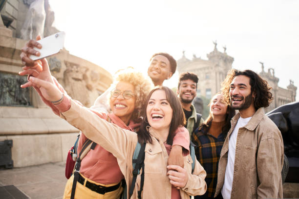 istock Diverse cultures students taking selfie with mobile phone outdoors. University college people having fun together 1439823840