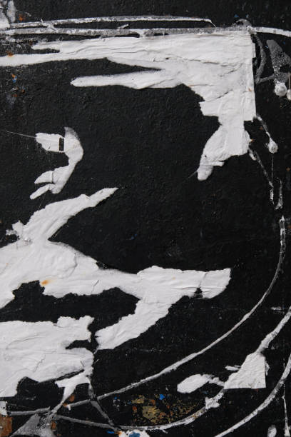 istock Peeled paper on black surface abstract background 1439824559