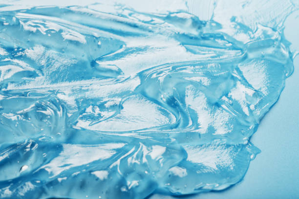 istock Antiseptic gel on a blue background in waves. 1439824712