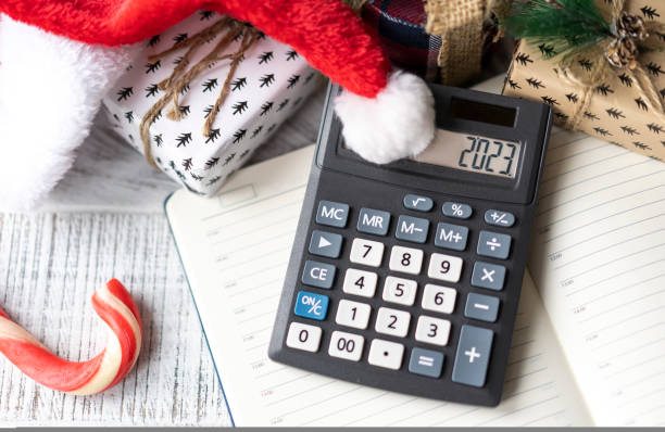 istock New Year's layout with calculator, Santa's hat and Christmas decorations 1439824714