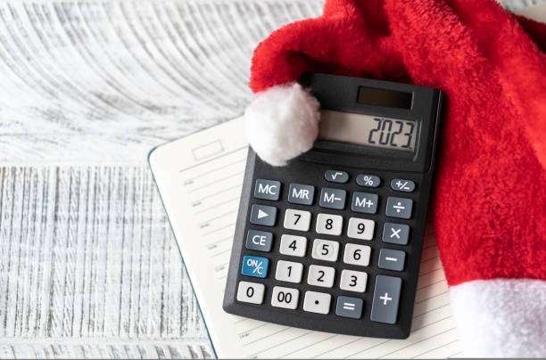 istock New Year's layout with calculator and Santa's hat 1439824791
