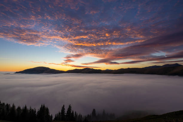 Panoramic view with setting sun from above the clouds