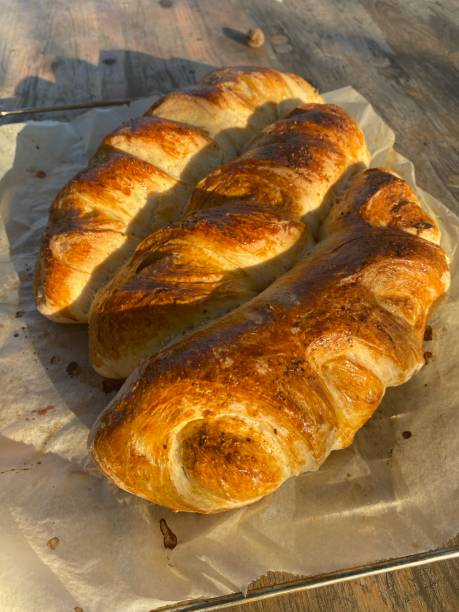 istock freshly baked bread on a wooden table in nature 1439827003