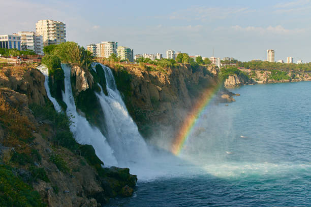 Lower Duden Waterfall in Antalya, Turkey. A beautiful landscape of waterfall, rainbow, sea and city Lower Duden Waterfall in Antalya, Turkey. A beautiful landscape of waterfall, rainbow, sea and city. High quality photo Duden stock pictures, royalty-free photos & images