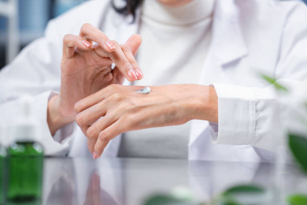 istock Beauty eco cosmetic research and development concept, Scientist or Pharmacist applying moisturizer lotion on her hand for efficacy testing of natural organic skincare products in laboratory 1439829309
