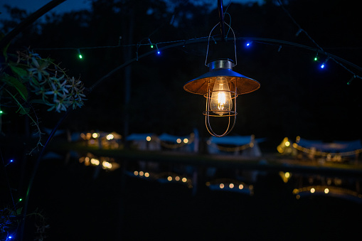 Night electric lamp hanging in camping tent light up