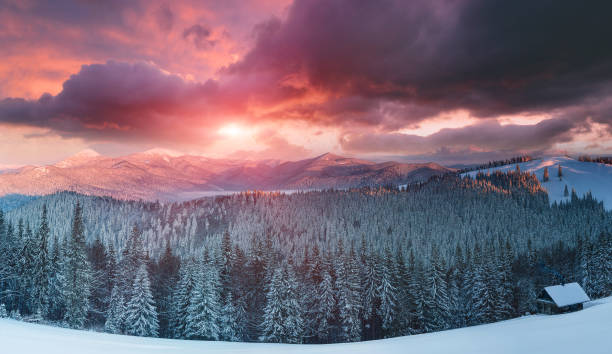 Panoramic landscape of winter morning in the mountains at sunrise. View of colorful and dramatic sky. stock photo