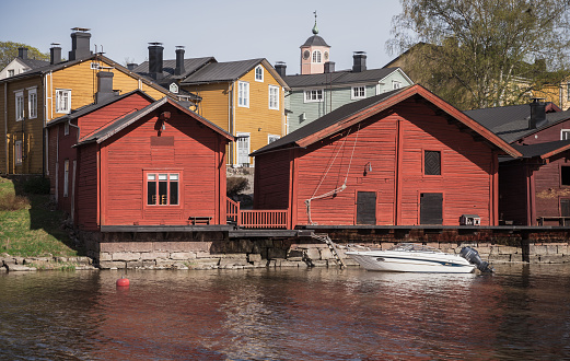 Porvoo, Finland - May 7, 2016: Traditional old red wooden houses and barns stand along the river coast at historical part of Porvoo town