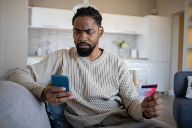 istock Man using her credit card to shop online 1439833357