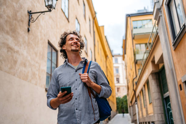istock Young Man Using Phone In An Alley In Stockholm 1439833468