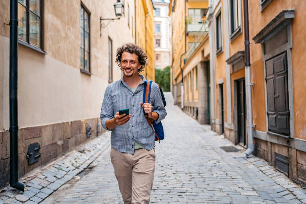 istock Young Man Using Phone In An Alley In Stockholm 1439833549