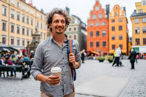 istock Young Man Walking And Drinking Coffee In Stockholm 1439834949