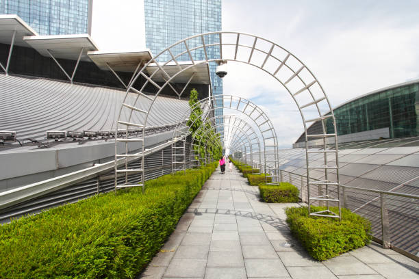 A walkway between buildings of the Shoppes at Marina Bay Sands shopping Mall with the Marina Bay Sands Hotel in the background.