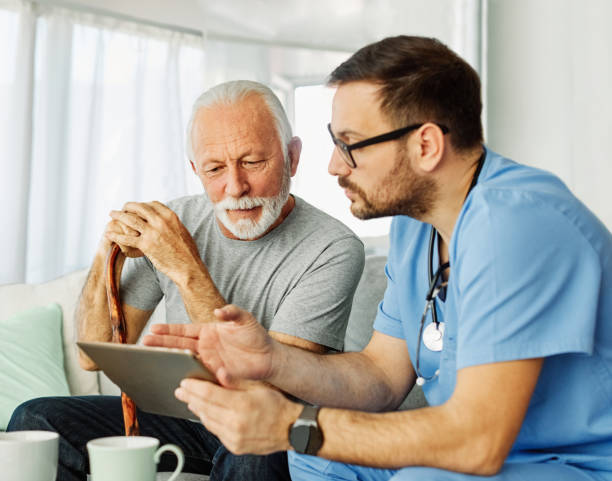 istock nurse doctor senior care tablet computer technology showing caregiver help assistence retirement home nursing elderly happy laughing man 1439838788