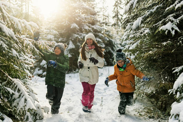 istock Kids exploring beautiful forest in winter 1439838905