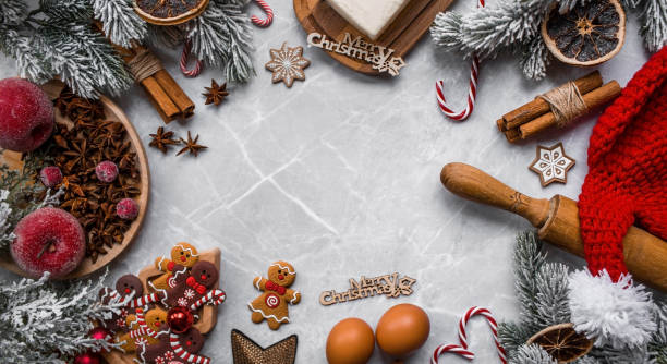 istock Happy New Year 2023. Banner with kitchen utensils, Christmas decorations, cinnamon, gingerbread and spruce on a marble background. A greeting card for Christmas. The concept of cafes and restaurants. 1439841692