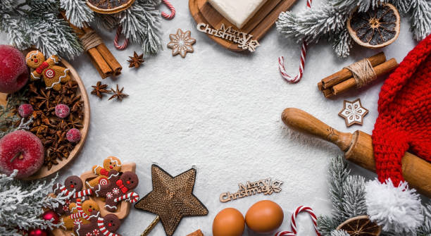 istock Happy New Year 2023. Banner with kitchen utensils, Christmas decorations, cinnamon, gingerbread and spruce on a marble background. A greeting card for Christmas. The concept of cafes and restaurants. 1439841696