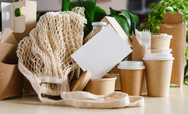 istock Empty white sheet with eco-friendly paper packaging and fabric bag shopping bags. The concept of zero waste 1439841973