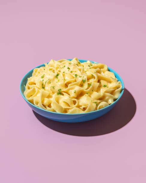istock Pasta alfredo dish isolated on a purple background 1439842034