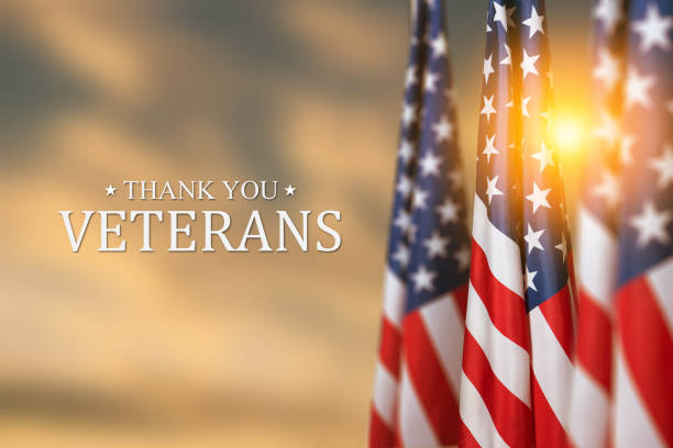 istock American flags with Text Thank You Veterans on sunset background. 1439842071