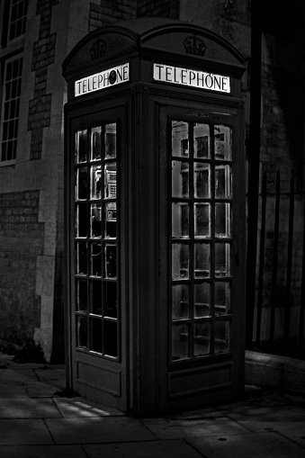 Telephone Booth on street corner on a rainy night in London.