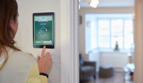 A woman using her smart Home Screen to keep control her homes energy output