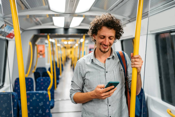 Young Man Using Phone In A Subway Train In Stockholm