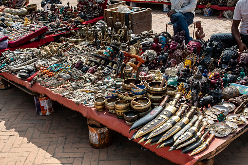 Kathmandu, Nepal - nov 6, 2019: close up of a cheap souvenir stalls, with knives, singing bowls, bracelets, necklaces and various trinkets
