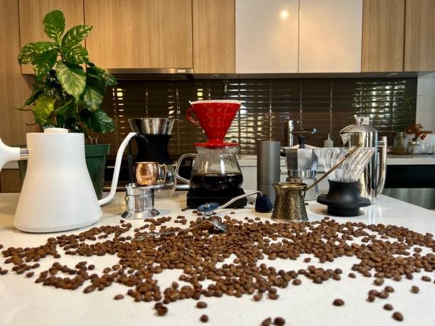 istock Craft coffee ad In foreground coffee beans are scattered on the table Different professional equipment on the table next to the coffee flower as well as different accessories for brewing coffee 1439856067