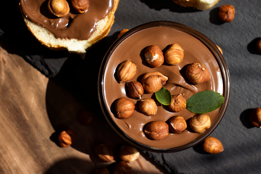 Chocolate spread, piece of bread, hazelnuts