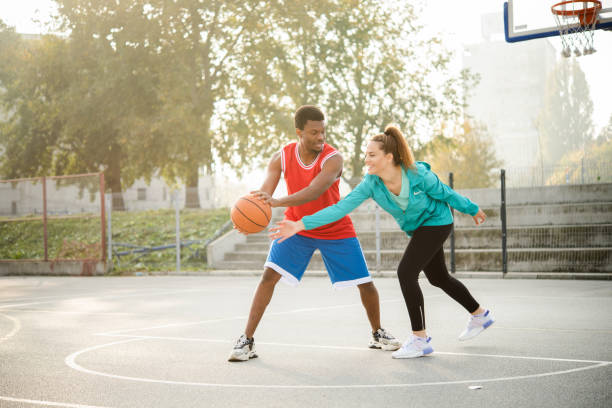istock Young couple playing basketball 1439860059