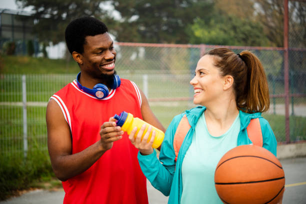 istock Young couple playing basketball 1439860154