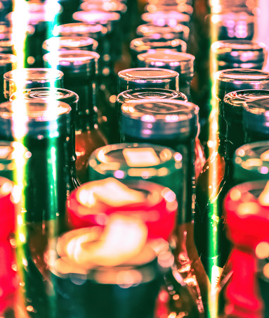 Canning jars at processing plant withe colorful light streaks.