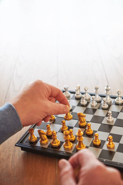 istock Unidentifiable middle aged man playing chess on a dining room table 1439861337